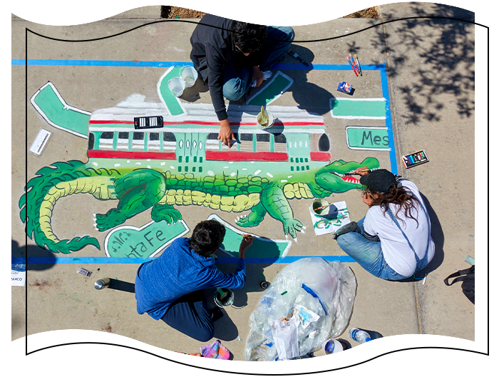 Showcase artists chalking sidewalk.