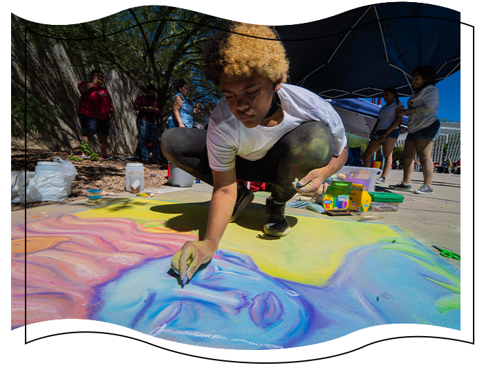 Person drawing a blue skin woman on the concrete