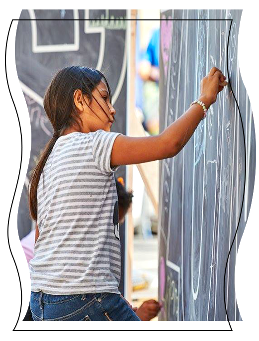 Girl drawing with chalk on wall