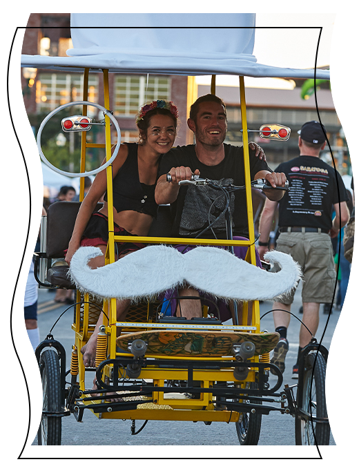 Man and woman riding a yellow cart